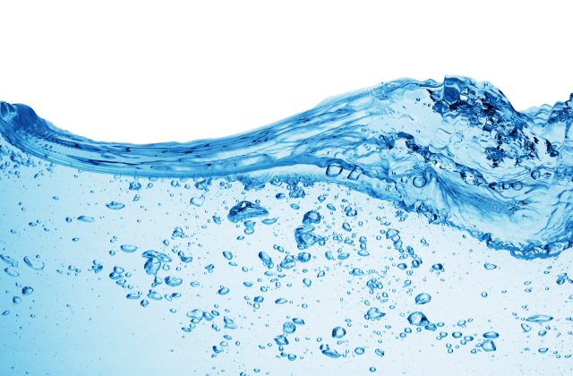 Bubbles forming in blue water, isolated